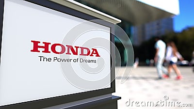 Street signage board with Honda logo. Blurred office center and walking people background. Editorial 3D rendering Editorial Stock Photo