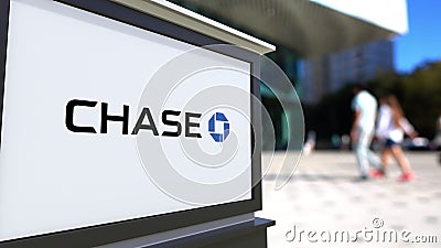 Street signage board with JPMorgan Chase Bank logo. Blurred office center and walking people background. Editorial 3D Editorial Stock Photo