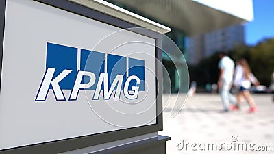 Street signage board with KPMG logo. Blurred office center and walking people background. Editorial 3D rendering Editorial Stock Photo