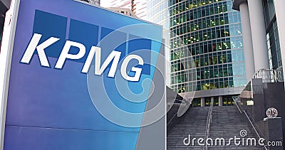 Street signage board with KPMG logo. Modern office center skyscraper and stairs background. Editorial 3D rendering Editorial Stock Photo