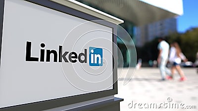 Street signage board with LinkedIn logo. Blurred office center and walking people background. Editorial 3D rendering Editorial Stock Photo