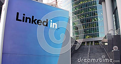 Street signage board with LinkedIn logo. Modern office center skyscraper and stairs background. Editorial 3D rendering Editorial Stock Photo
