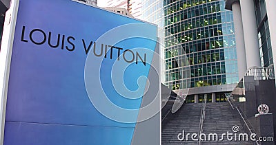 Street signage board with Louis Vuitton logo. Modern office center skyscraper and stairs background. Editorial 3D Editorial Stock Photo