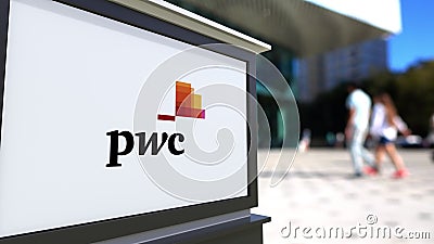 Street signage board with PricewaterhouseCoopers PwC logo. Blurred office center and walking people background Editorial Stock Photo