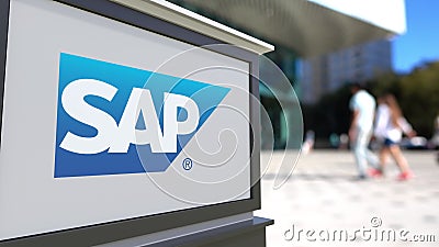 Street signage board with SAP SE logo. Blurred office center and walking people background. Editorial 3D rendering Editorial Stock Photo