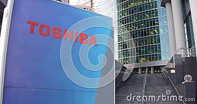 Street signage board with Toshiba Corporation logo. Modern office center skyscraper and stairs background. Editorial 3D Editorial Stock Photo