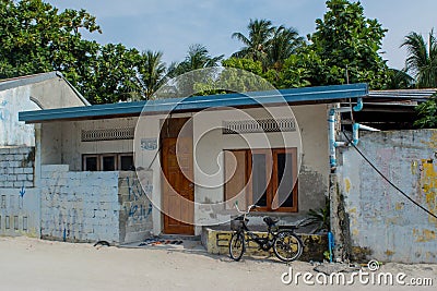 Street with small typical living local house at the Maamigili island Stock Photo