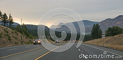 Street at sunset on road trip, mountain range around kamloops, Canada in fall Stock Photo