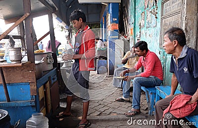 Street trader sells fast food for hungry people on the busy street in Kolkata Editorial Stock Photo