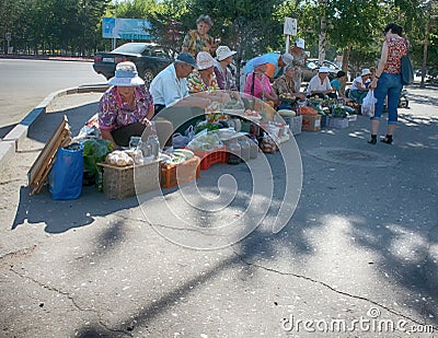 street trading poor retired grandmother in hot sun Editorial Stock Photo