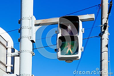 Street traffic light crosswalk sign against blue sky Stock Photo