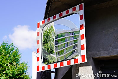 Street traffic red white convex mirror in road safety concept in city center Stock Photo