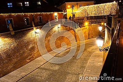 Street under the Bridge of Lies ( Podul Minciunilor ) decorated with christmas lights at night in Sibiu, Romania Editorial Stock Photo