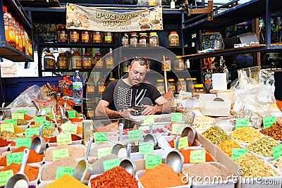 Street vender selling colorful spices Editorial Stock Photo