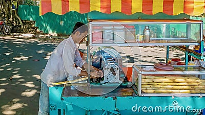 A street vendor in Cambodia preparing sugarcane juice. Editorial Stock Photo
