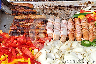 Street vendor grill with hot dogs and veggies Stock Photo