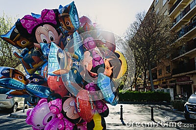 Street vendor with many children`s inflatable balloons with cartoon shapes Editorial Stock Photo