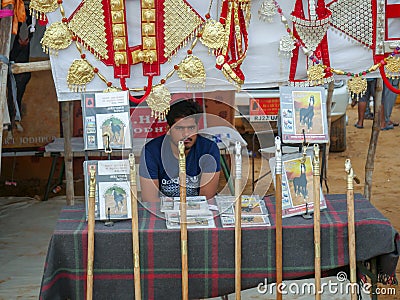 A street vendor selling bamboo sticks and horse decoration items on stall Editorial Stock Photo