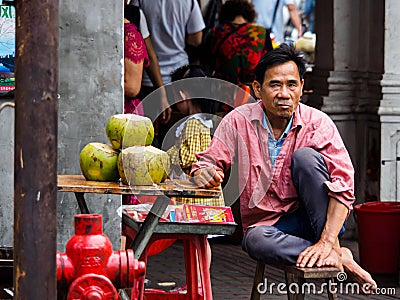 Asian Chinese street vendor selling coconut water Editorial Stock Photo