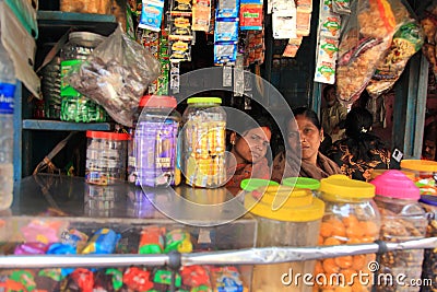 Street vendor sits in her small shop Editorial Stock Photo
