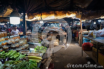 Street vendor and stall full of fresh produce and fruit at night Editorial Stock Photo