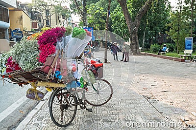 Street vendors selling various types of flowers from their bicycle in Hanoi Old Quarter. Editorial Stock Photo