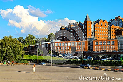 Street view, brick red buildings, architecture on a summer sunny day. Dnipro city, Dnepropetrovsk, Stock Photo