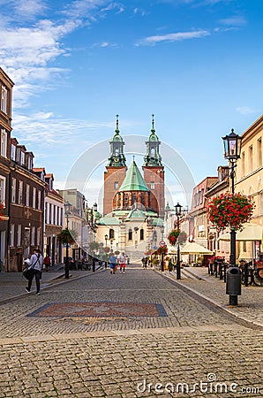 Street view in the city center and Cathedral Basilica of the Assumption of Blessed Virgin Mary and St. Adalbert: Gniezno / Poland Editorial Stock Photo