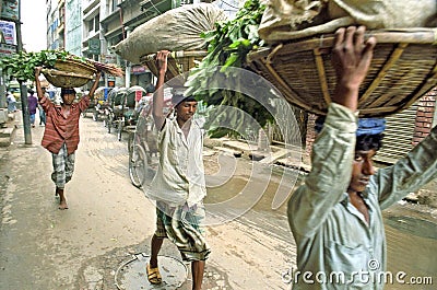 Street view with porters and rickshaws, Dhaka Editorial Stock Photo