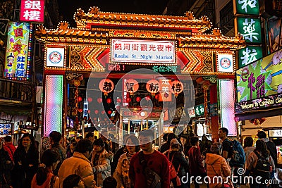 Street view of Raohe Street food Night Market full of people and Editorial Stock Photo