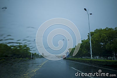 Street view taken through the windshield of the car in rainy weather Stock Photo