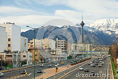 Street View of Tehran with Milad Tower and Alborz Mountains Stock Photo