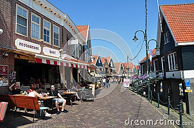 Street view of tourists at outdoor restaurants of Volendam quayside, Netherlands Editorial Stock Photo