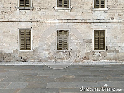 Street View of Wall With Shuttered Windows Stock Photo