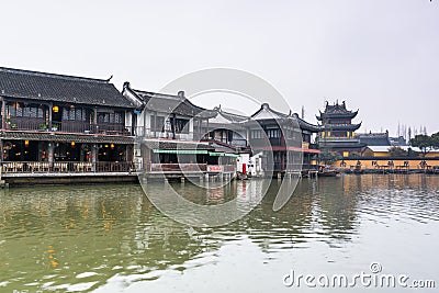 Street view with wooden historic buildings and buddhist temple in Zhujiajiao in a rainy day, an ancient water town in Shanghai, Editorial Stock Photo
