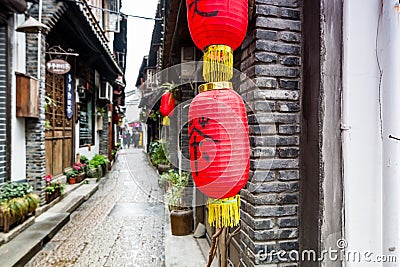 Street view with wooden historic buildings and red lantern in Zhujiajiao in a rainy day, an ancient water town in Shanghai, built Editorial Stock Photo