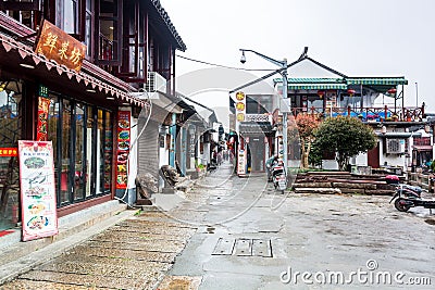 Street view with wooden historic buildings in Zhujiajiao in a rainy day, an ancient water town in Shanghai, built during Ming and Editorial Stock Photo