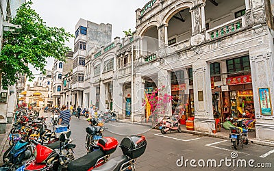 Street view of Xinmin west road with of old colonial sotto portico buildings in Haikou Qilou old town Hainan China Editorial Stock Photo
