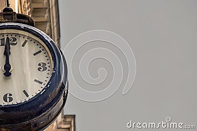 Street vintage clock on an old building on gray sky background. Part or a Half of the dial of retro watches Stock Photo