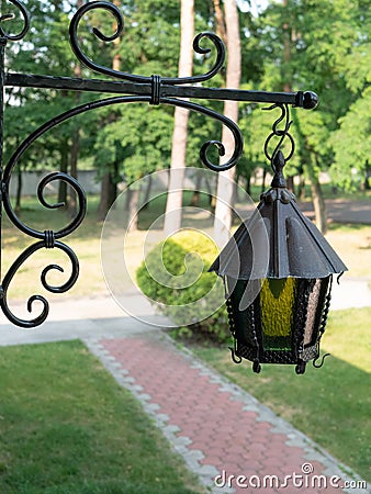 Street vintage lantern on steel forged signboard Stock Photo