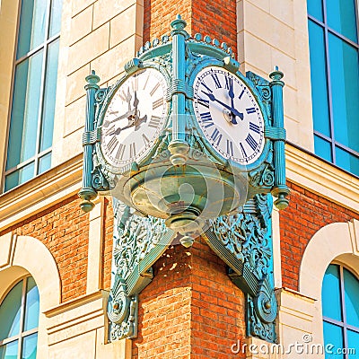 Street vintage watches hanging on a brick building. Editorial Stock Photo