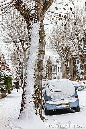 Street winter cityscape with snow terraced houses and frozen cars Editorial Stock Photo