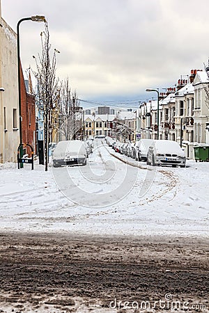 Street winter cityscape with snow terraced houses and frozen cars Editorial Stock Photo