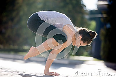 Street yoga: crane pose Stock Photo