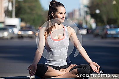 Street yoga: meditation beside the highway Stock Photo