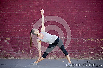 Street yoga: Utthita Trikonasana Pose Stock Photo