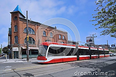 trams running on tracks embedded in the road are a common form of public transit in the older parts of downtown Toronto Editorial Stock Photo