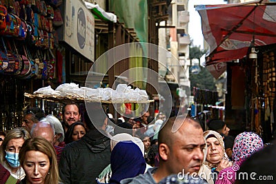 Of the streets of the Cairo& x27;s market and a guy with a basket selling typical bread Editorial Stock Photo