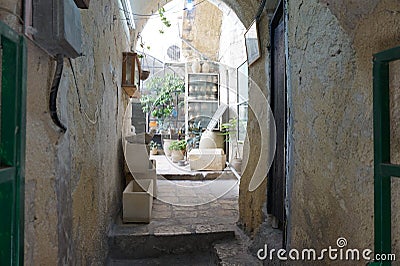 The streets of the old city keep secrets in their labyrinths. Stock Photo