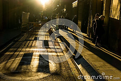 Streets with unrecognizable people with high contrast and dark background Editorial Stock Photo